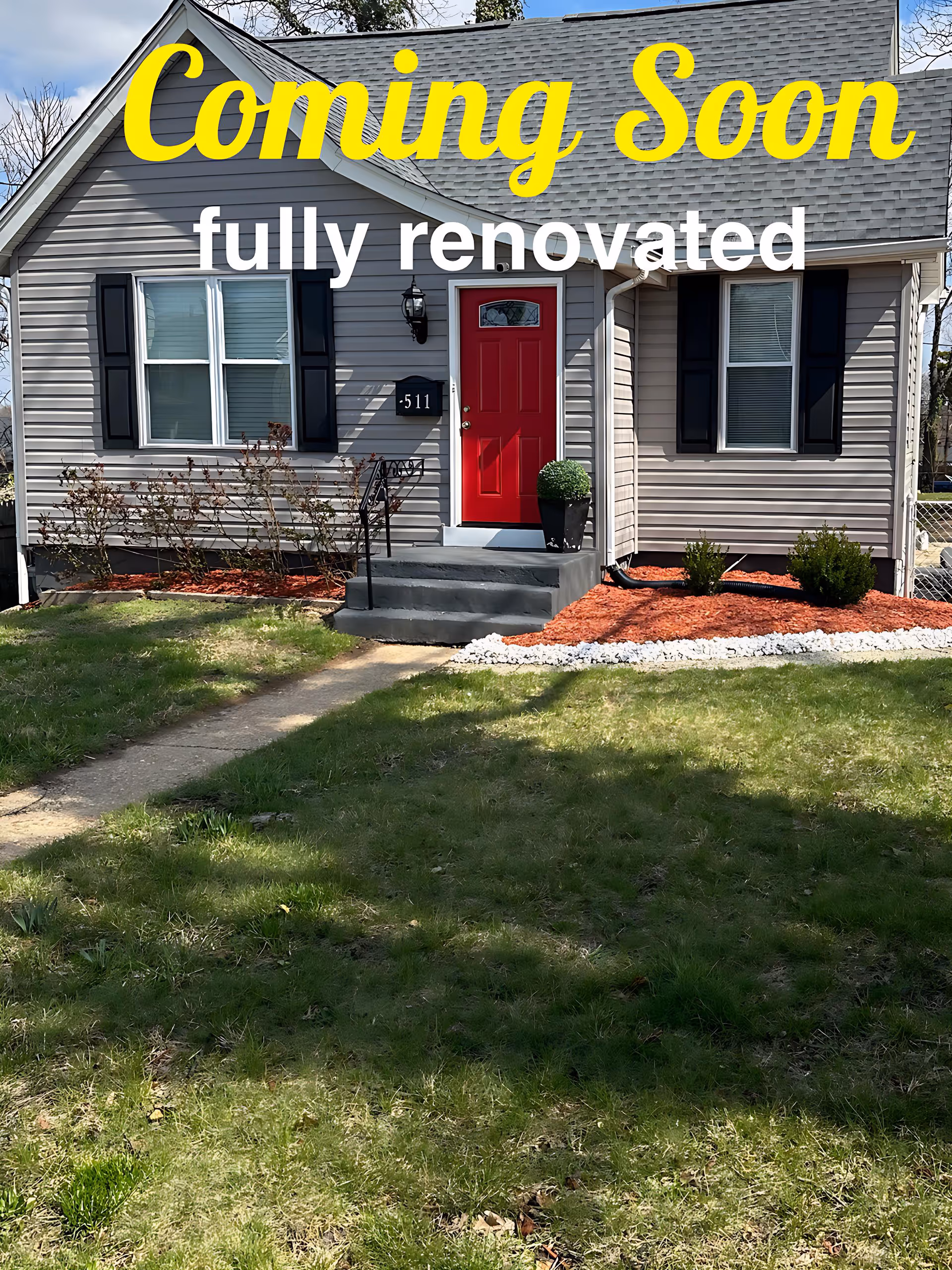 Front view of a single-story house with a red door and Coming Soon overlay.