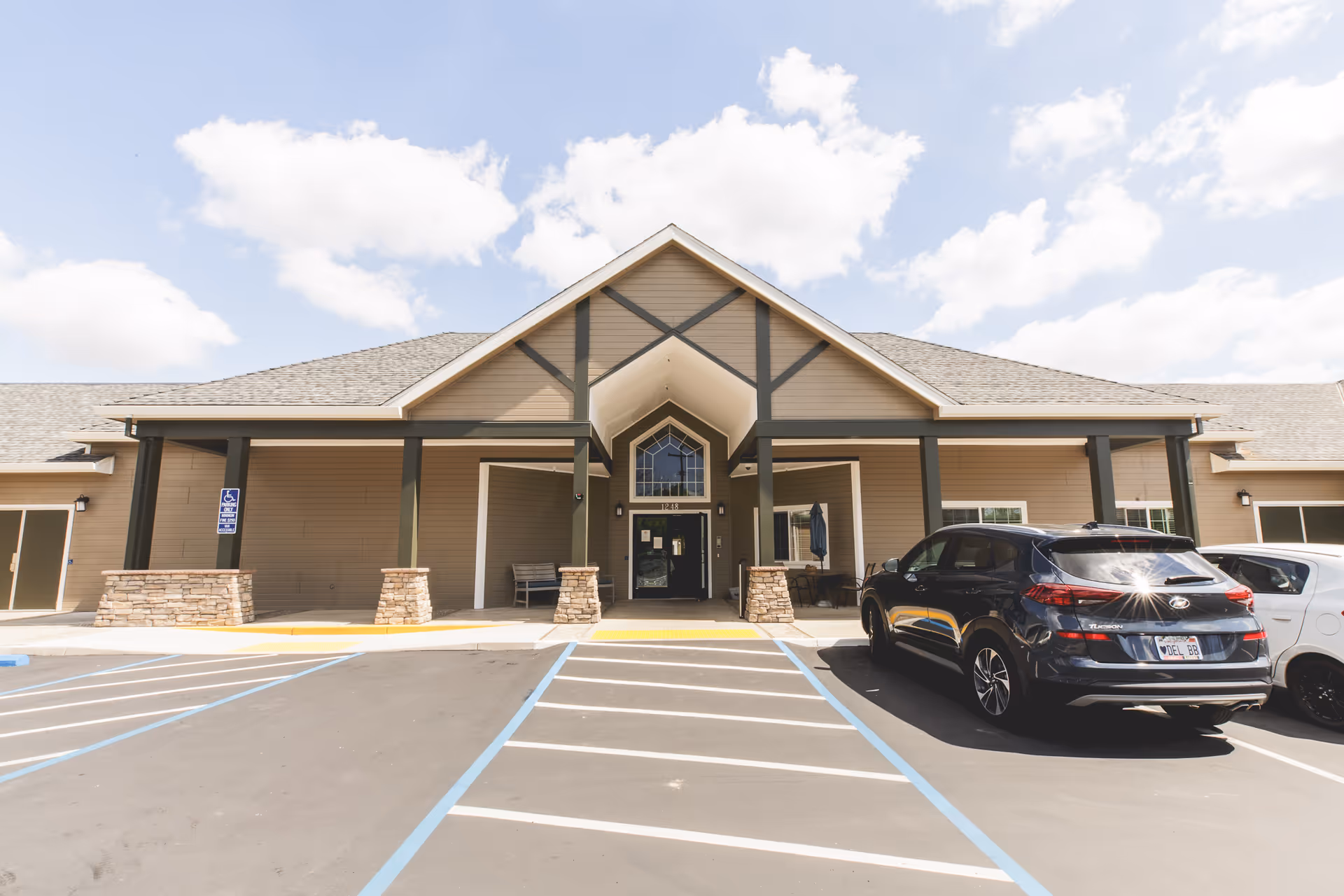 Morningstar Assisted Living building front with stone columns and a parking lot.