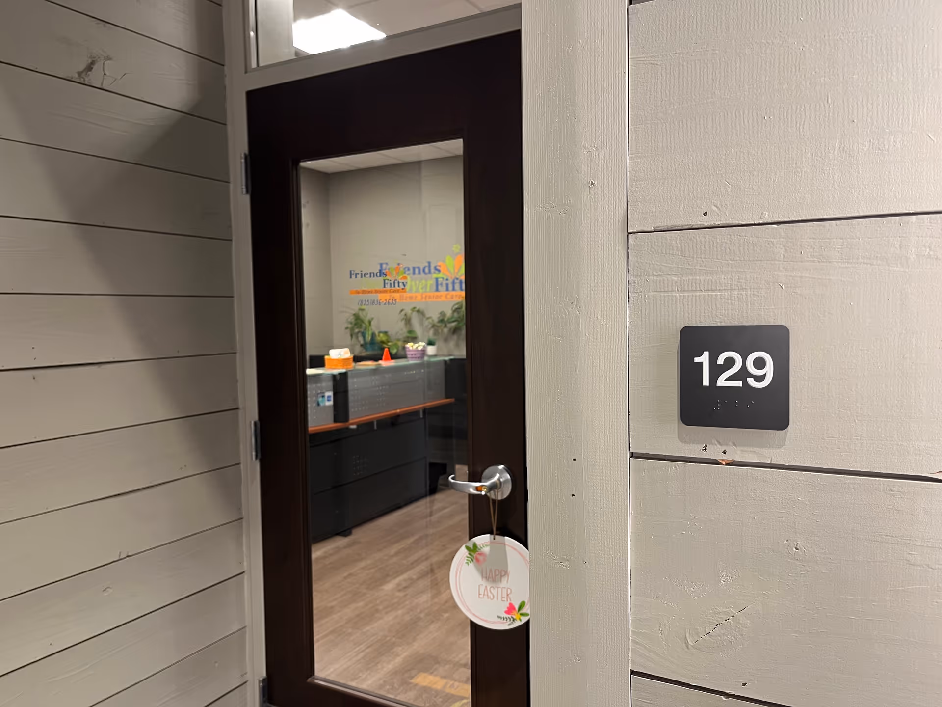 Door to unit 129 opens into a reception area with desks inside.