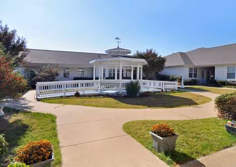 Whitley Place facility exterior with a white gazebo and curved walkway