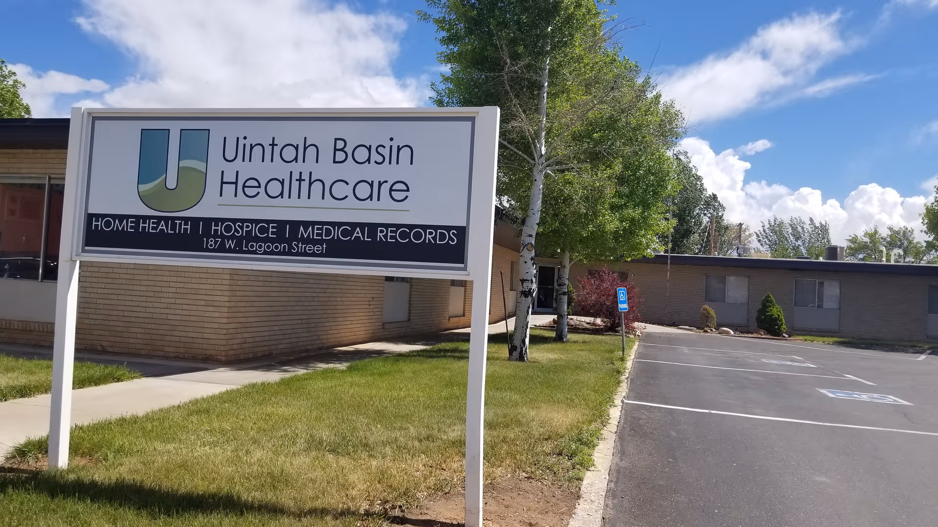 Front sign reading Uintah Basin Healthcare, with building, trees, and a parking lot.