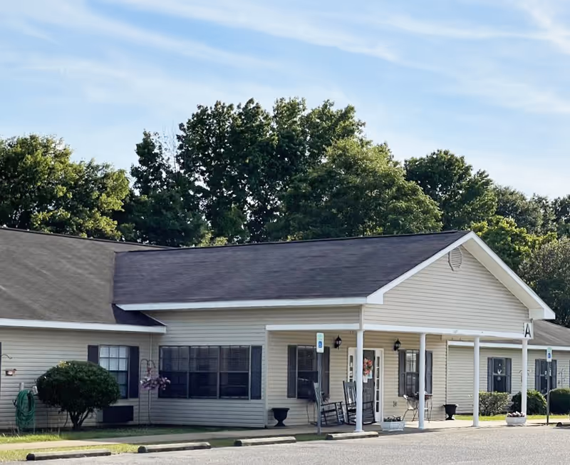 Front exterior of Gardens of Wetumpka II, a single-story senior living facility with a covered entry.