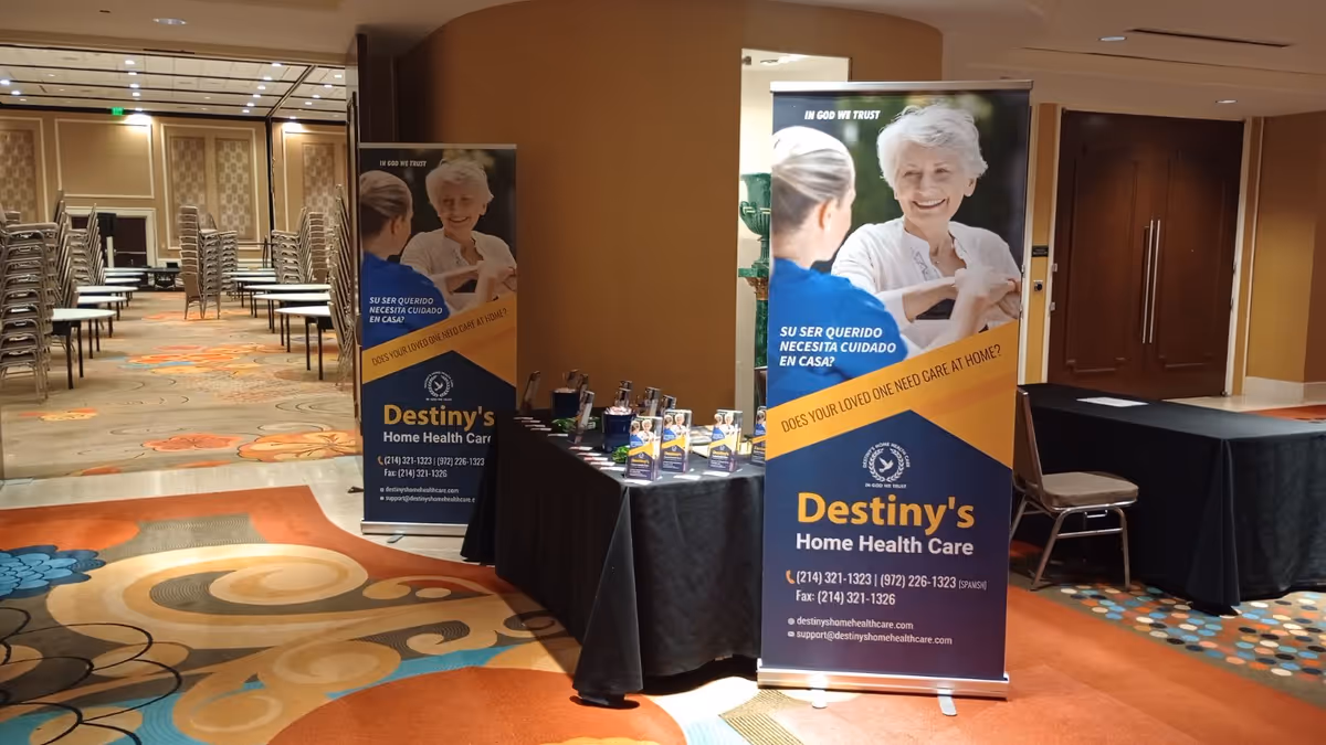 Conference setup in a ballroom with Destiny's Home Health Care banners and display tables.