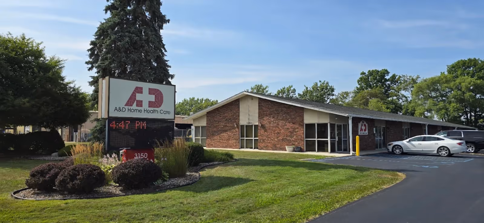 Brick, single-story facility with A&D Home Health Care sign and parking lot.
