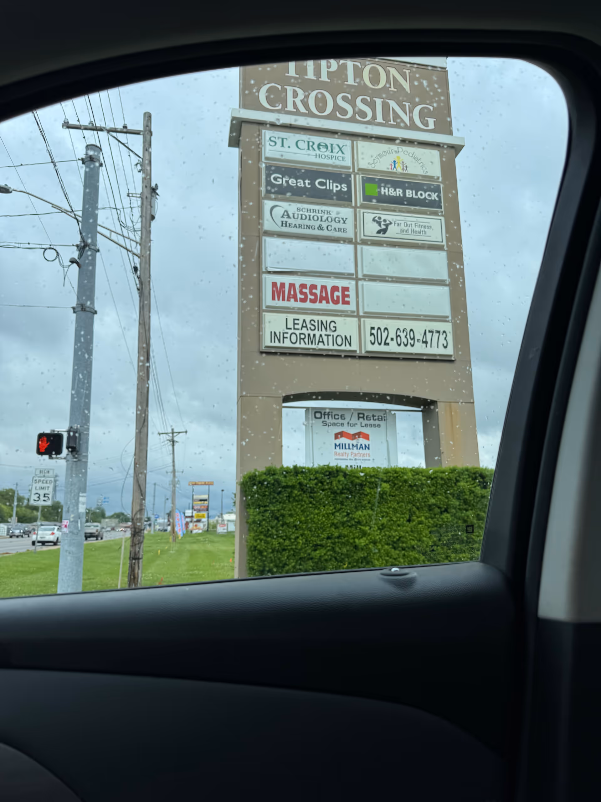 Outdoor sign tower at Tipton Crossing showing St. Croix Hospice among shops.