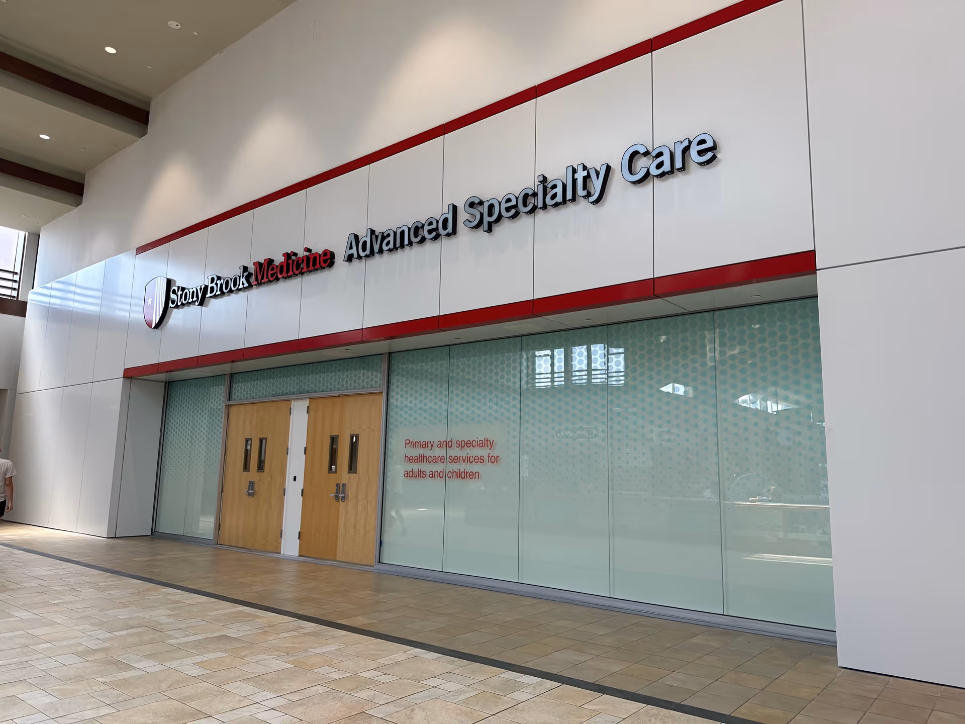 Front view of Stony Brook Medicine Advanced Specialty Care entrance with glass doors