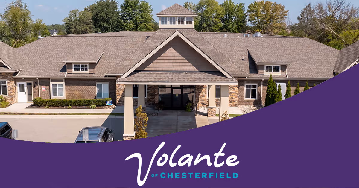 Front entrance of a single-story senior living building with a purple banner reading "Volante of Chesterfield" across the bottom.