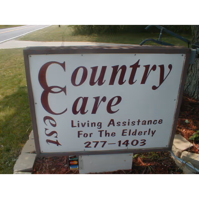 Outdoor sign for Country Care Living Assistance for the Elderly on a grassy lawn.