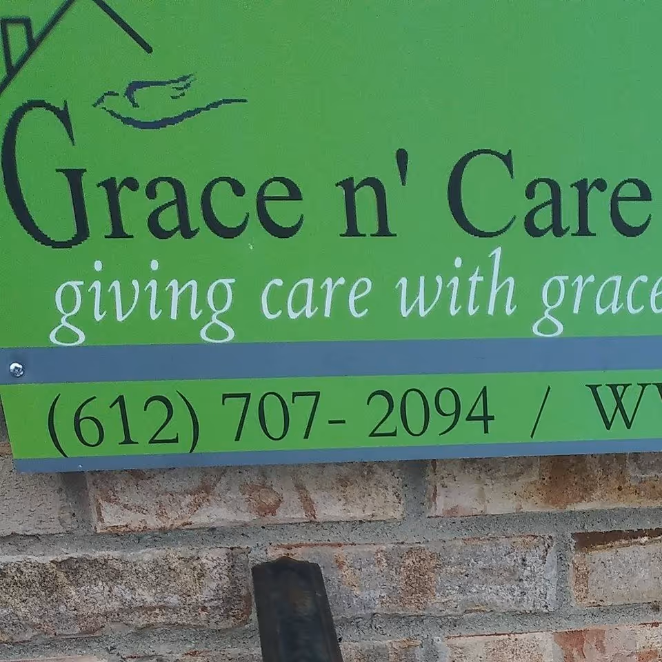 Bright green Grace n' Care sign on a brick exterior wall with phone number.