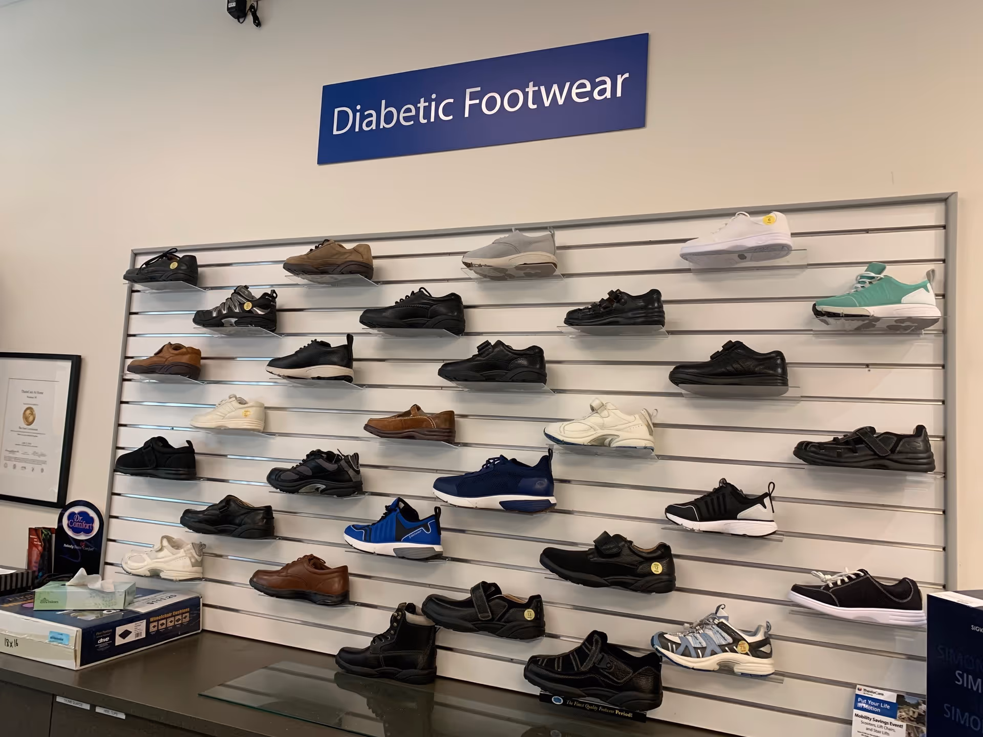 Diabetic footwear display wall with assorted shoes in a facility interior
