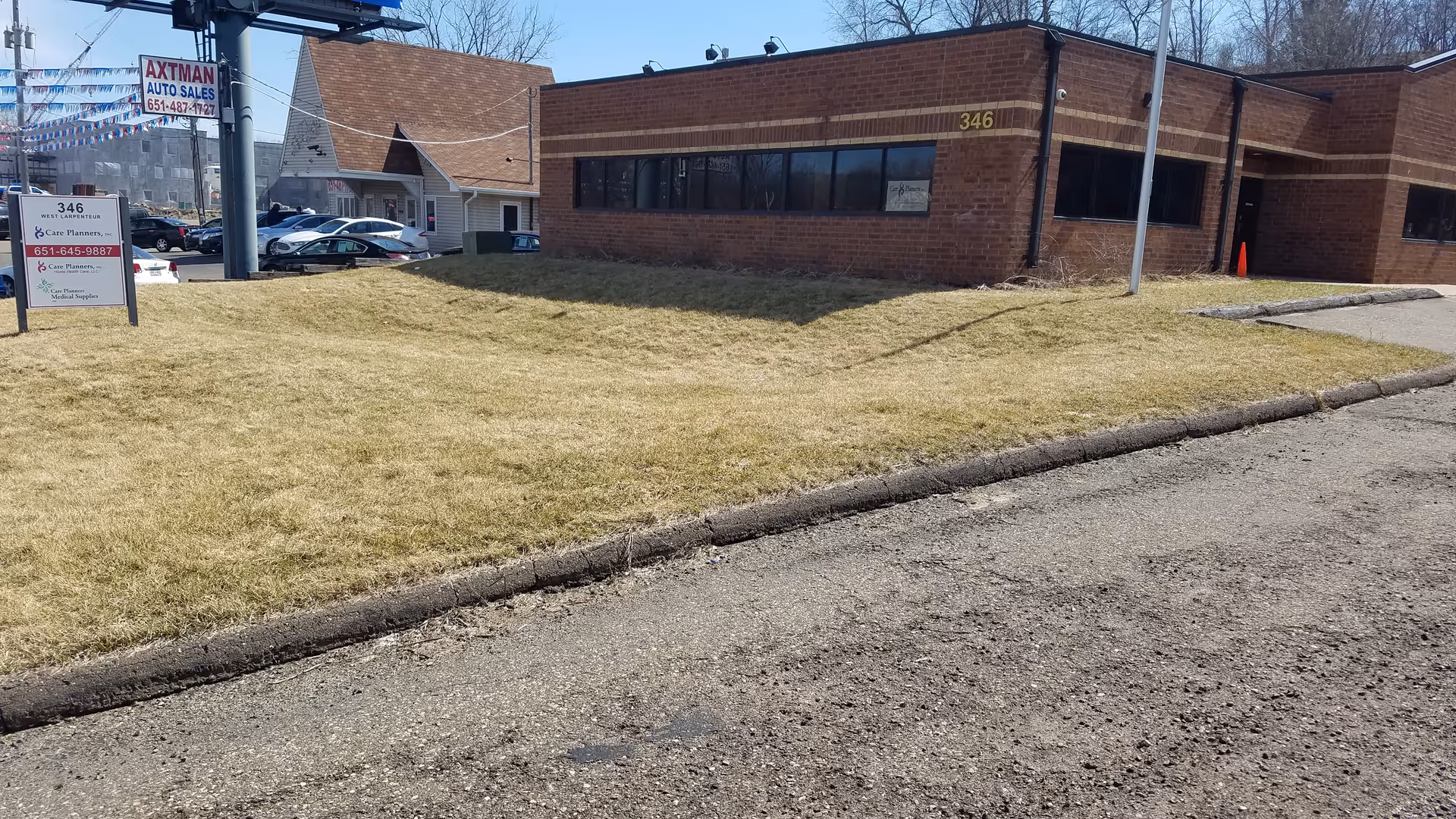 Exterior view of a brick facility with address 346 and a grassy lawn.