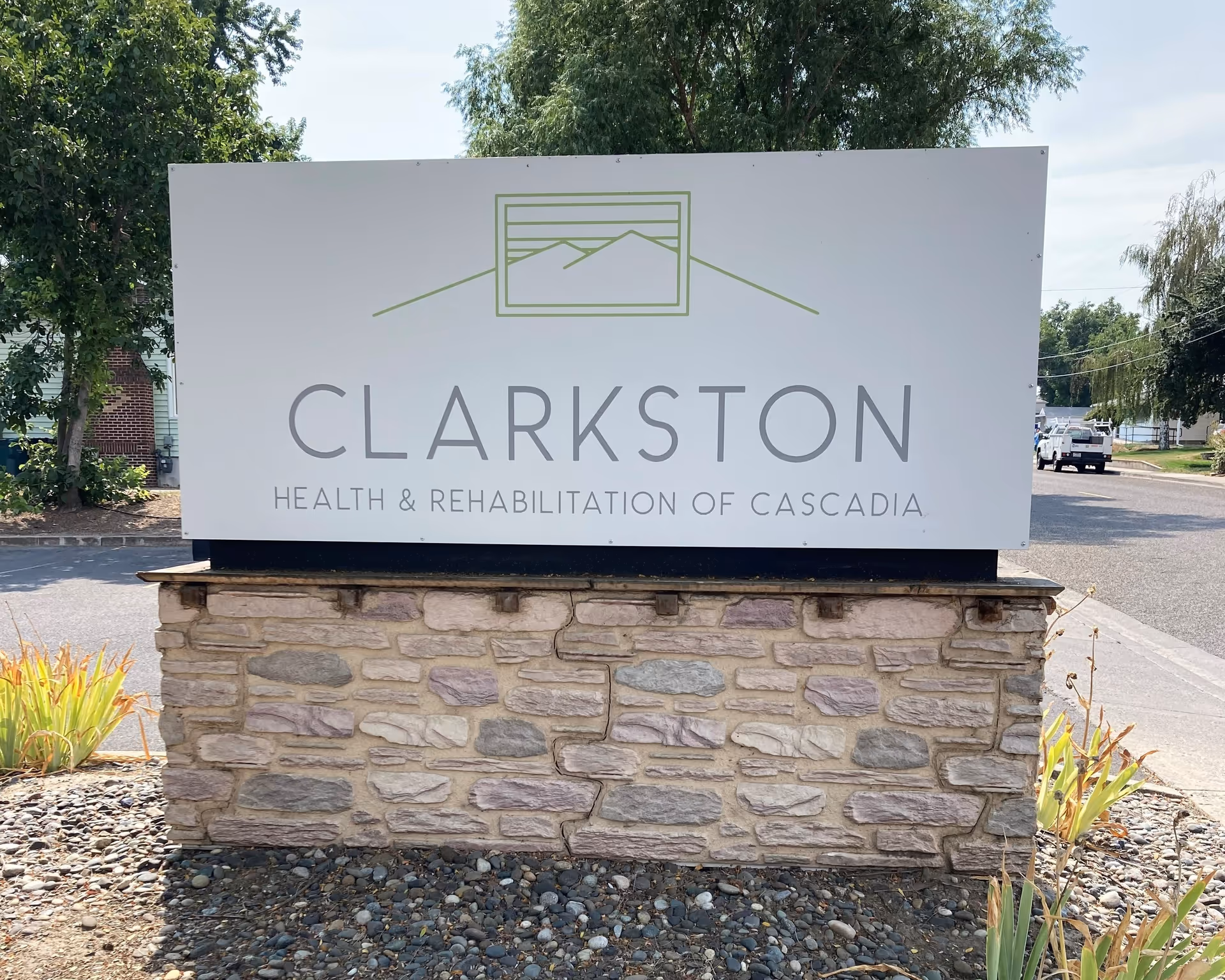 A large sign on a stone pedestal reading Clarkston Health & Rehabilitation of Cascadia.