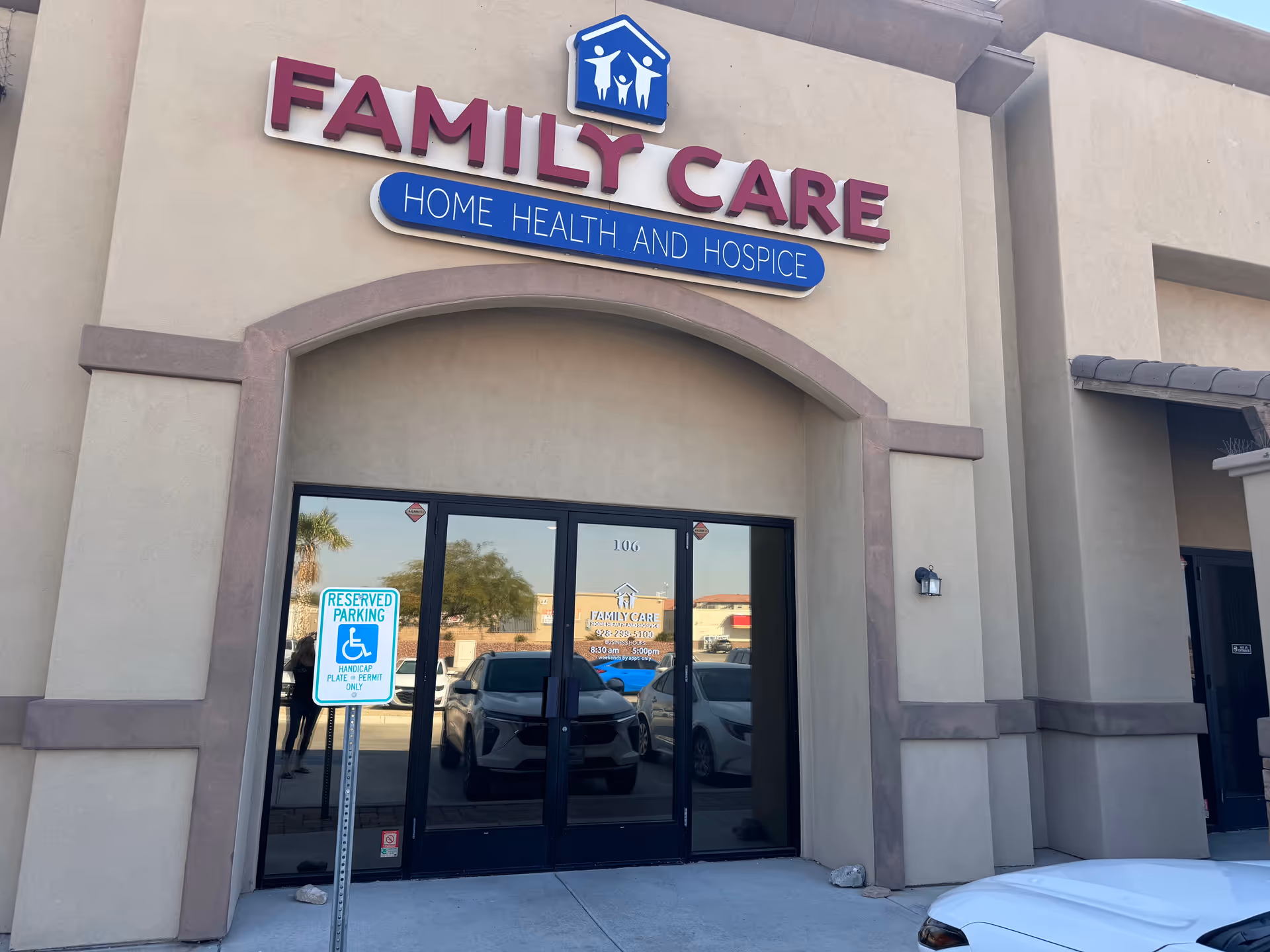 Exterior view of a building entrance with Family Care sign and handicap parking sign.