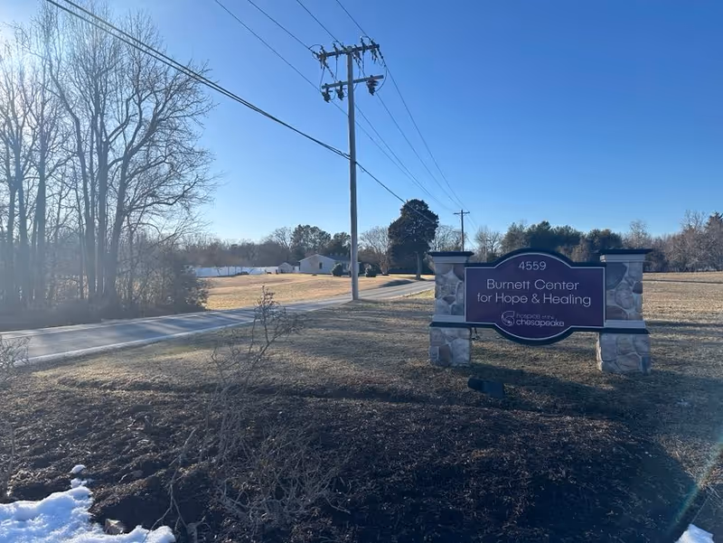 Outdoor view of the Burnett Center for Hope and Healing sign near a road.