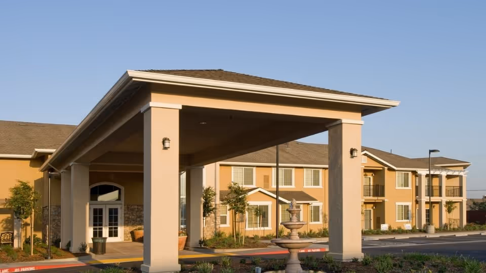 Exterior view of Prestige Assisted Living at Manteca featuring a porte-cochère entrance.