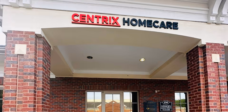 Brick storefront with Centrix Homecare sign and glass entrance doors under a beige canopy.