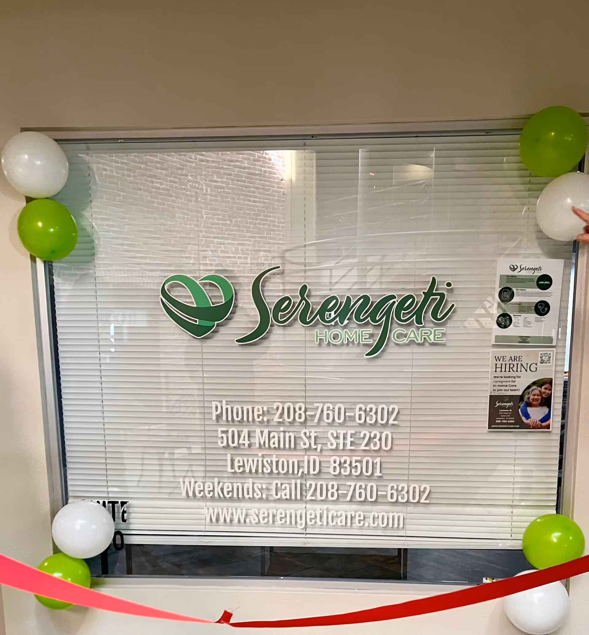 Entrance window displays Serengeti Home Care logo with balloons and flyers nearby.