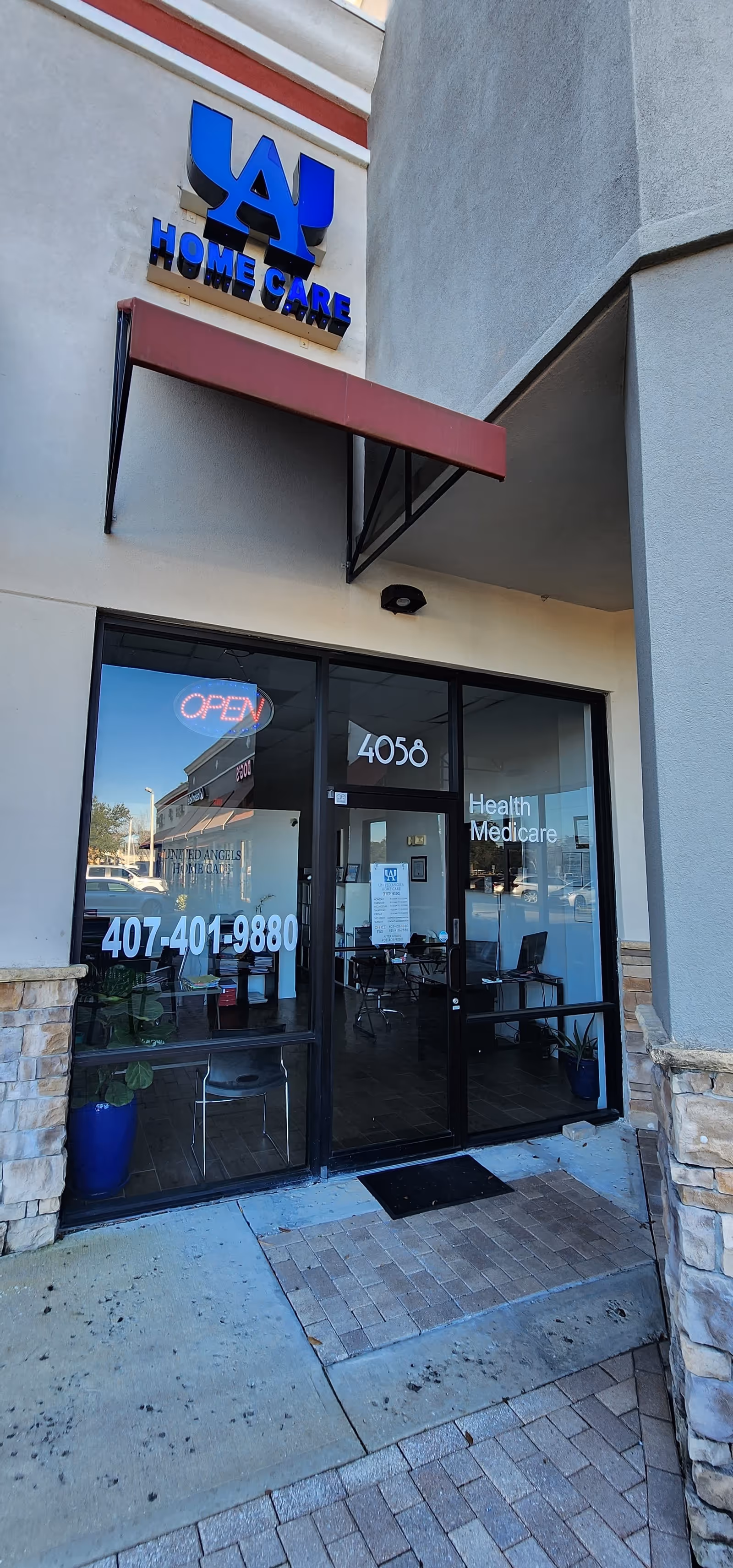 Exterior view of a storefront with United Angels Home Care signage and open glass doors