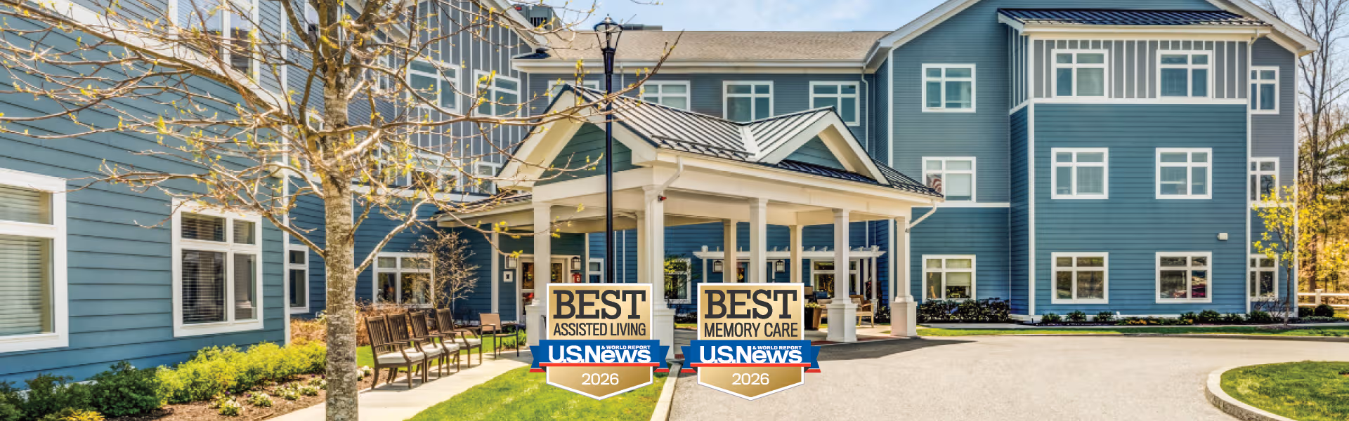 Blue multi-story senior living facility exterior with a covered entrance and outdoor seating area.