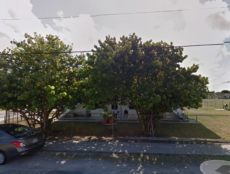 Front view of Bay Square at Yarmouth with large trees obscuring the building.