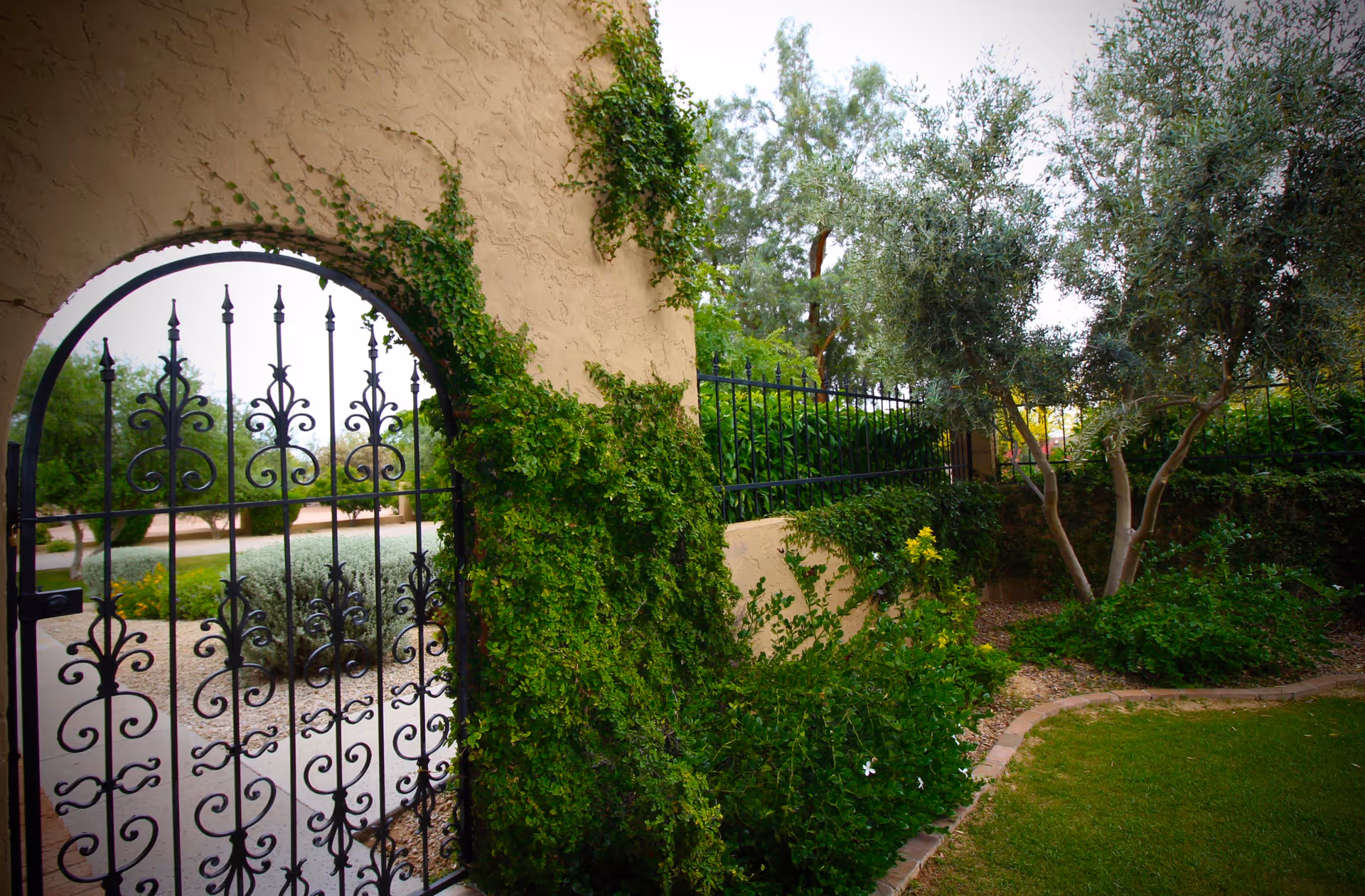 The Paradise Assisted Living Home exterior with an ivy-covered gate and lush landscaping.
