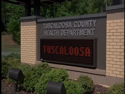 Exterior view of Tuscaloosa County Health Department sign at entrance.