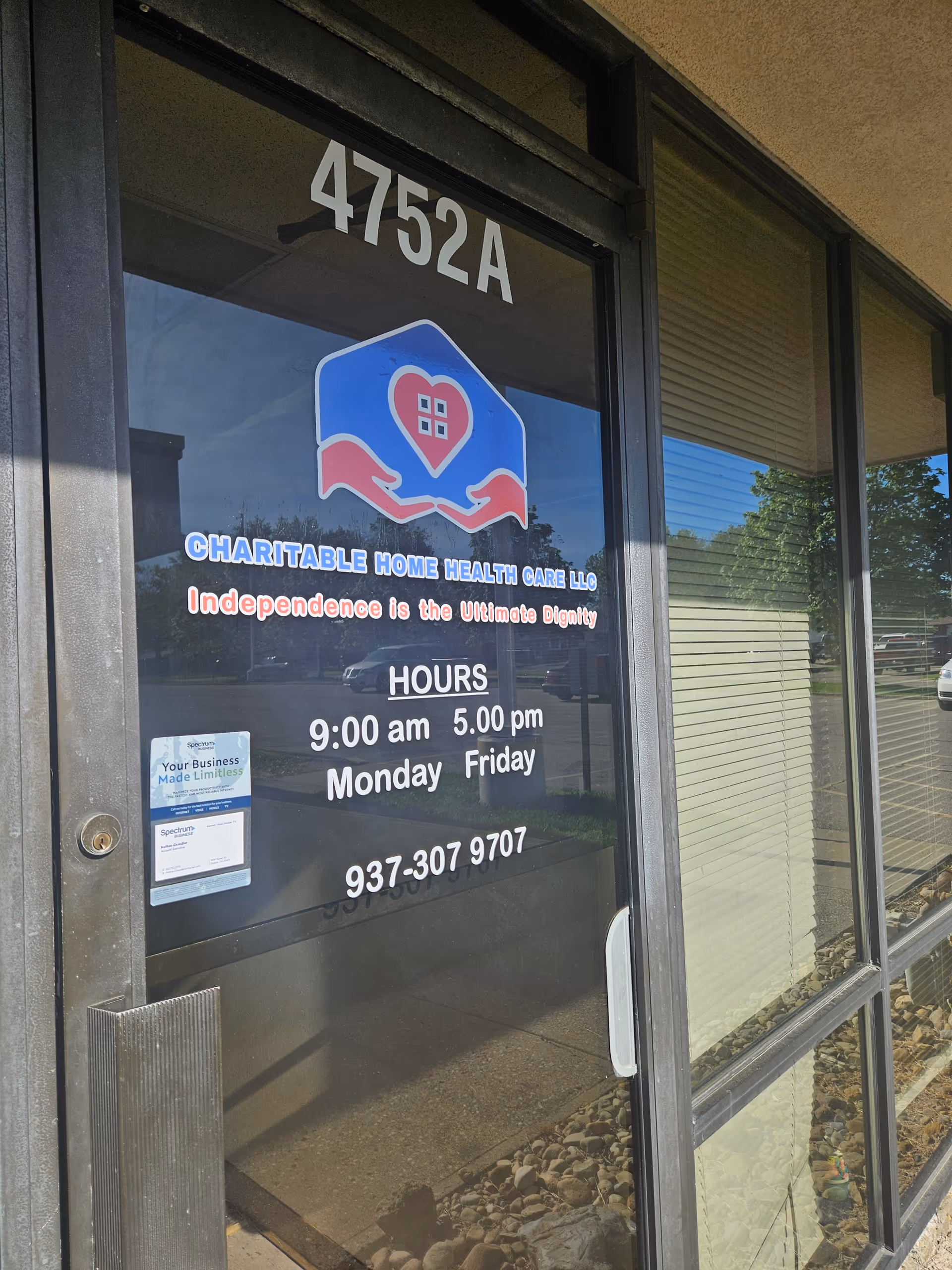Glass storefront door shows 4752A, Charitable Home Health Care LLC sign and business hours.