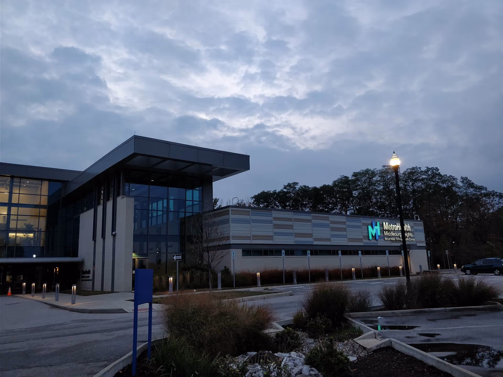 Exterior view of MetroHealth Middleburg Heights facility at dusk with a modern entrance