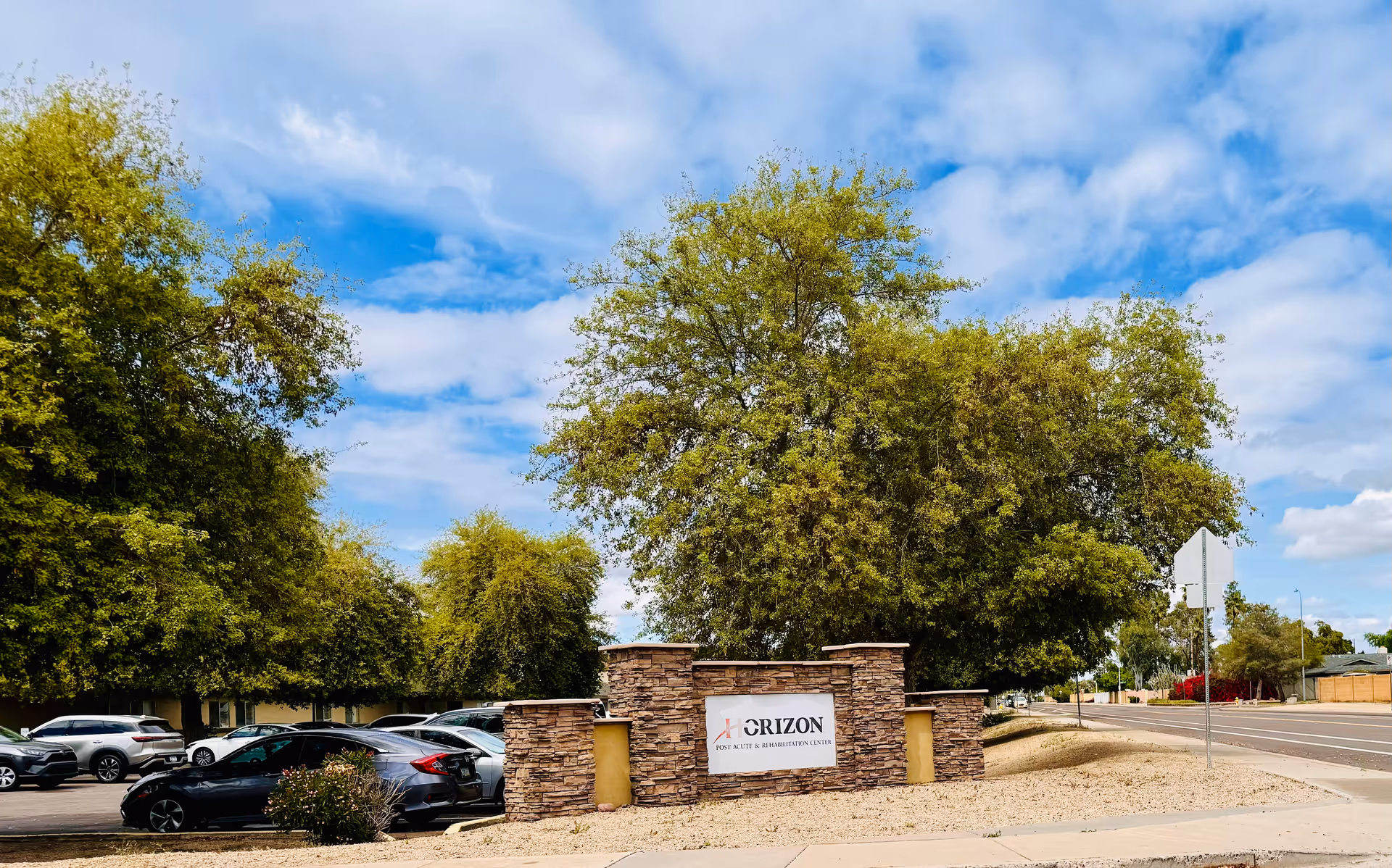 Exterior view of Horizon Post Acute and Rehabilitation Center entrance with stone sign and trees