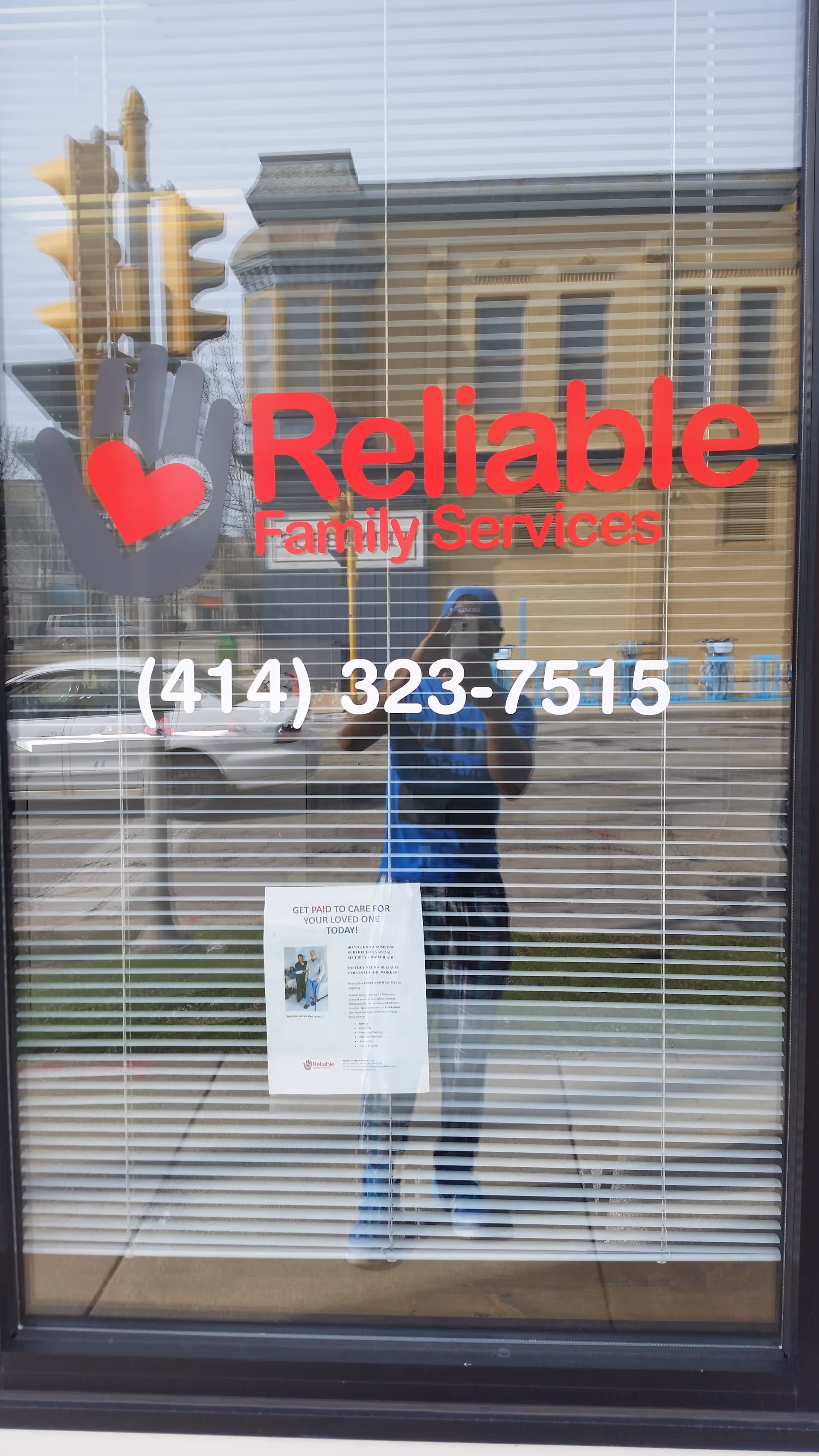 Glass entrance door for Reliable Family Services with logo, heart icon, and phone number.