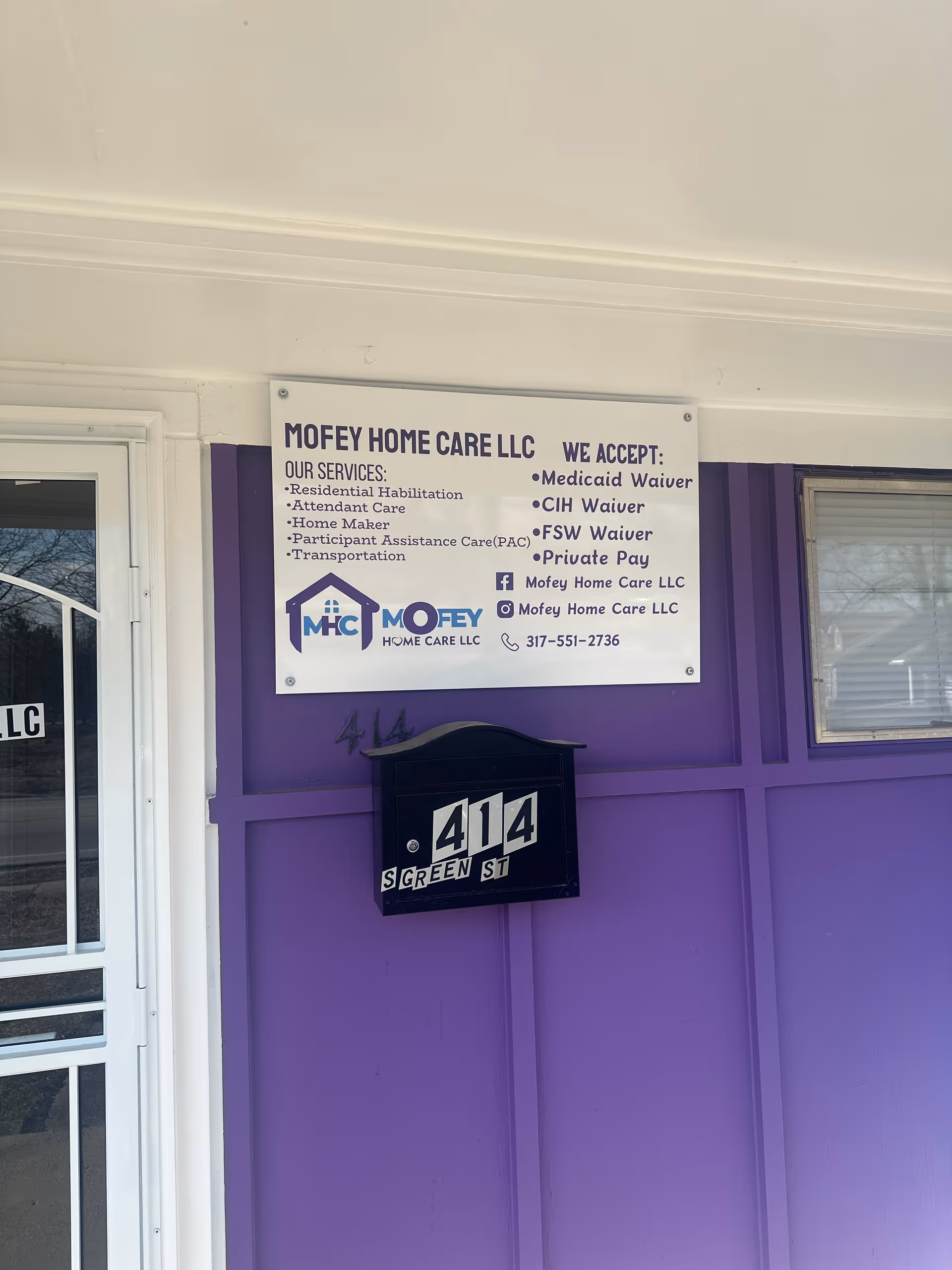Purple building exterior featuring MOFEY Home Care LLC sign and mailbox.