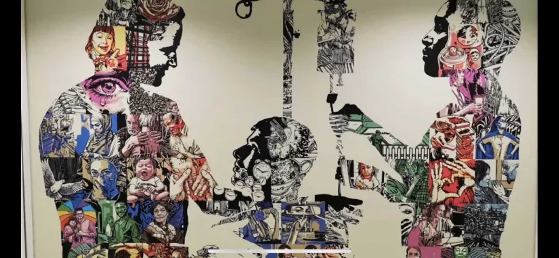 Colorful wall mural with collaged silhouettes of people inside an interior facility.