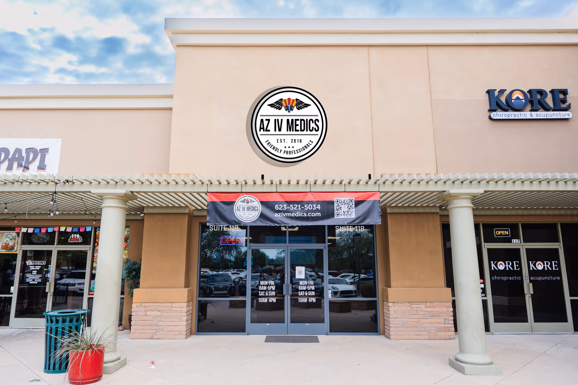 AZ IV Medics storefront with banner, round logo, and adjacent KORE Chiropractic signage.