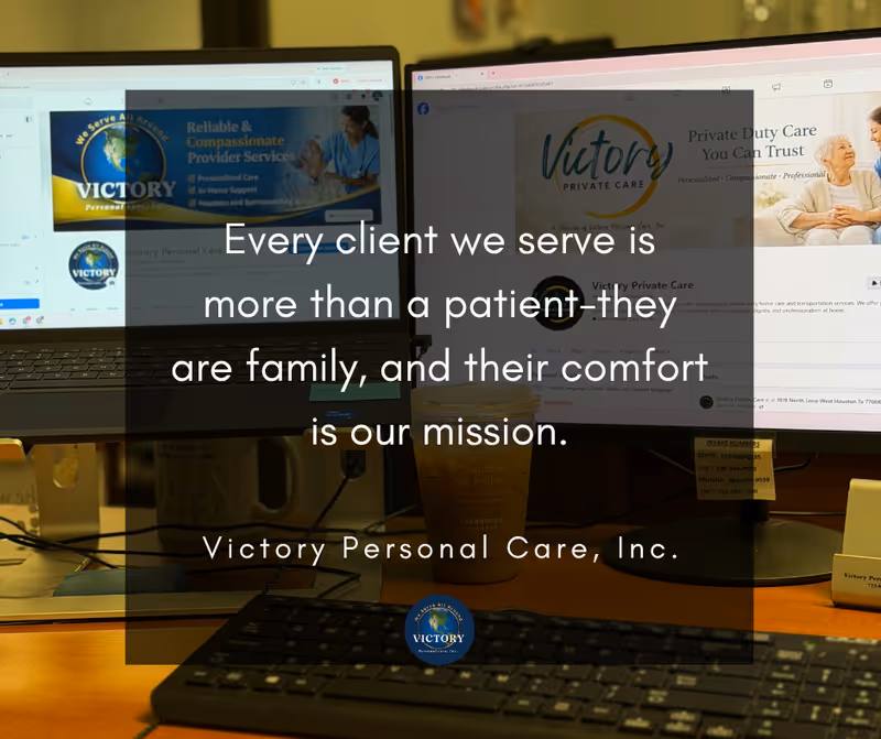 Two computer monitors display Victory Personal Care branding on a cluttered office desk.