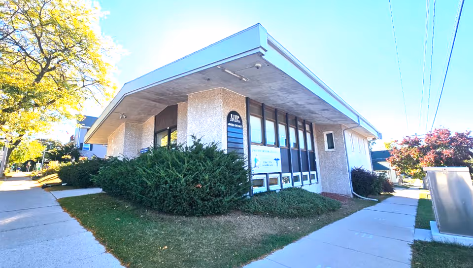 A single-story building with large windows and a sign for Universal Home Health Care, Inc.