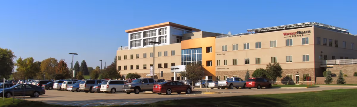 Exterior view of Waverly Health Center building with a large parking lot in front.