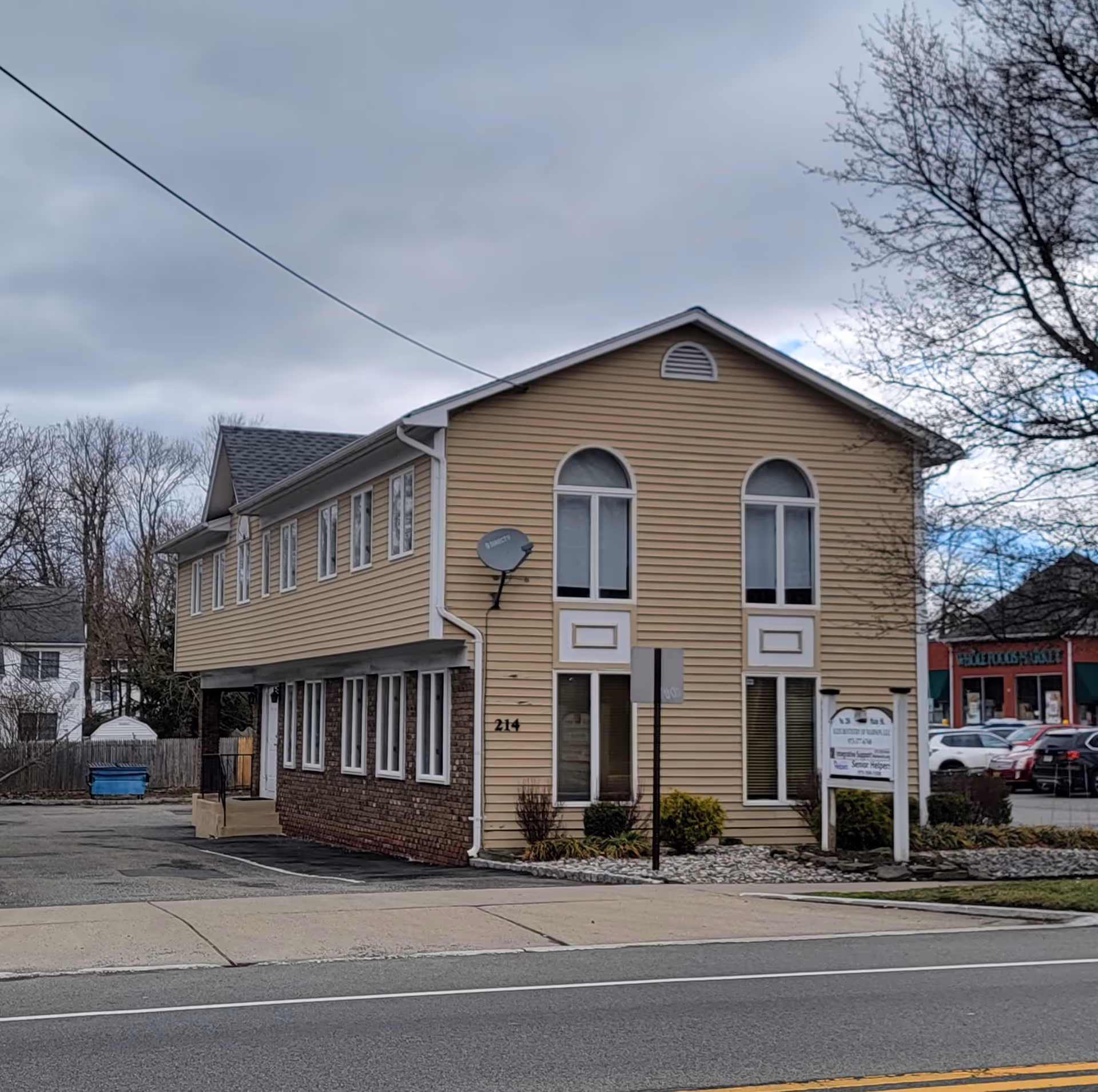 Exterior view of Senior Helpers of Madison, NJ building with beige siding and arched windows