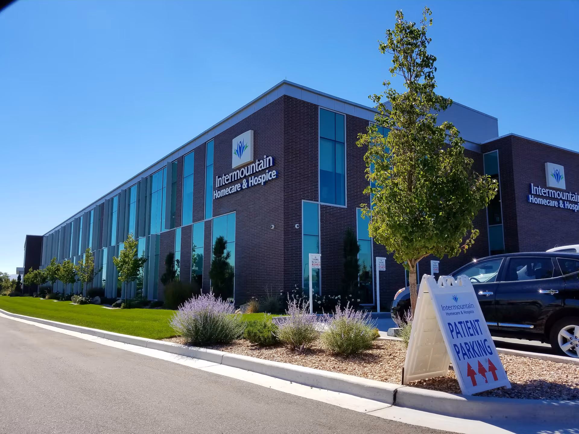 Exterior view of Intermountain Homecare & Hospice building with parking and landscaped grounds.