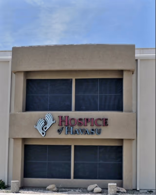 Front view of a beige hospice building with the Hospice of Havasu sign.