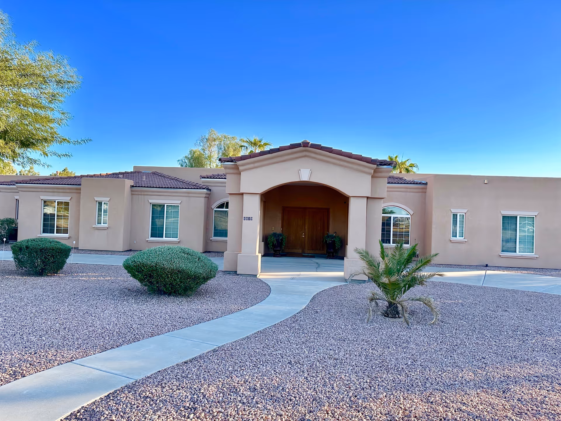 Assisted Living of Scottsdale exterior with curved entrance and desert landscaping