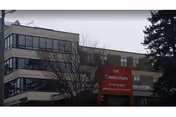 Exterior view of a multi-story building with a red Cheltenham Nursing and Rehab Center sign.