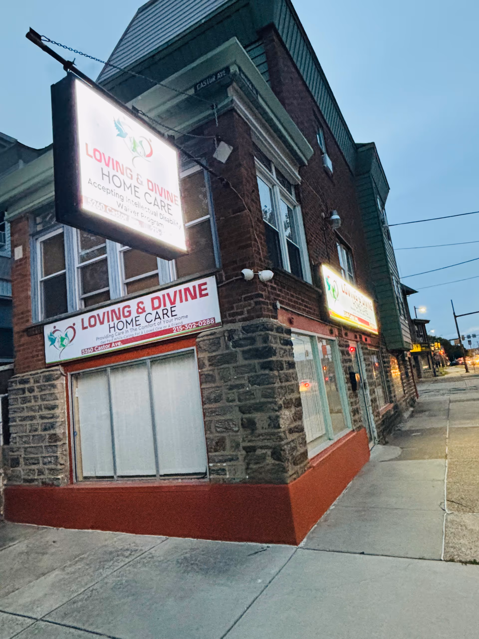 Exterior view of a brick building with Loving and Divine Home Care signs.