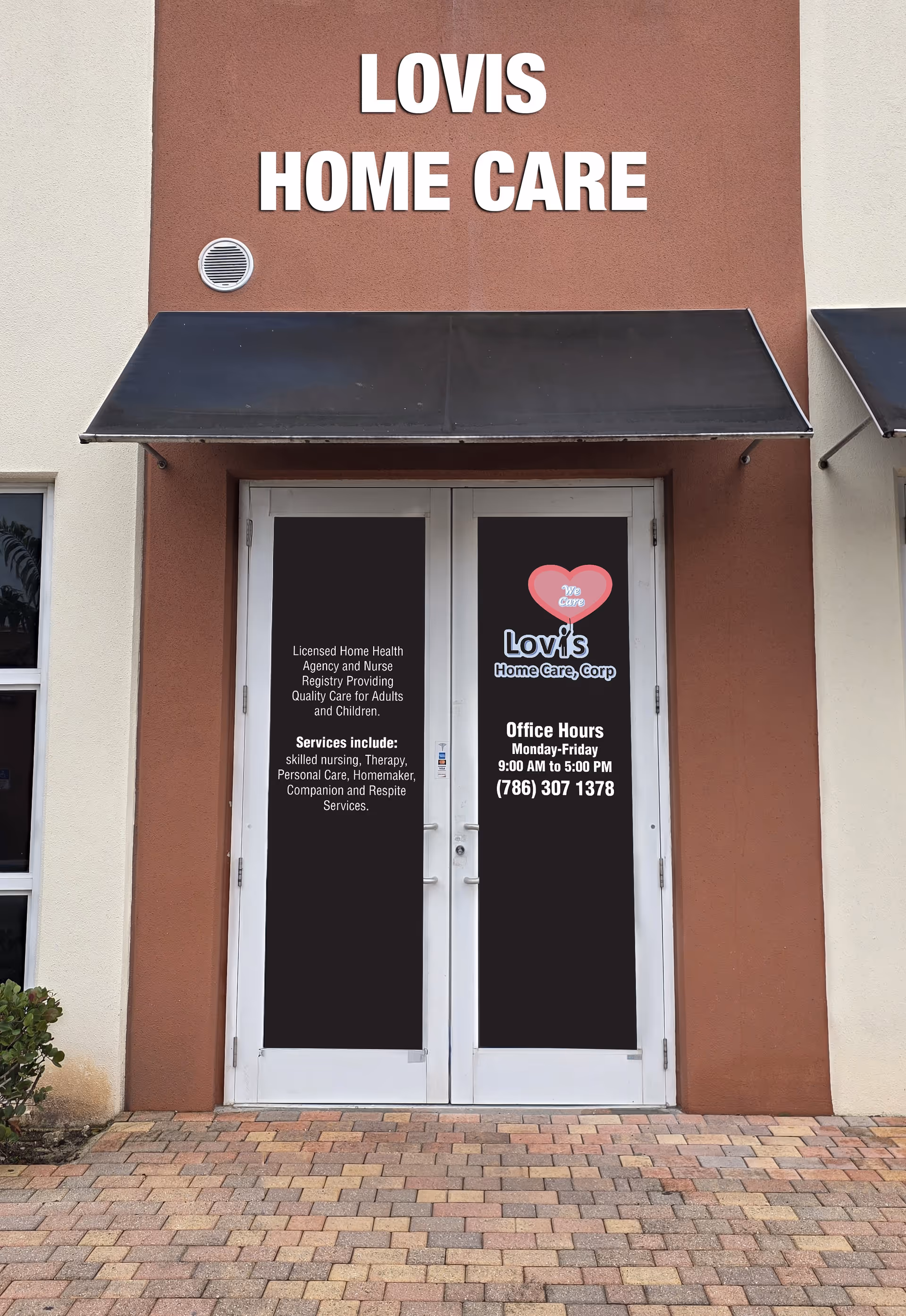 Front entrance of Lovis Home Care, Corp., with double doors and signage.
