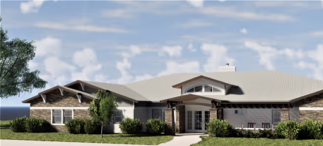 A single-story senior living facility with brick exterior and landscaped entrance.