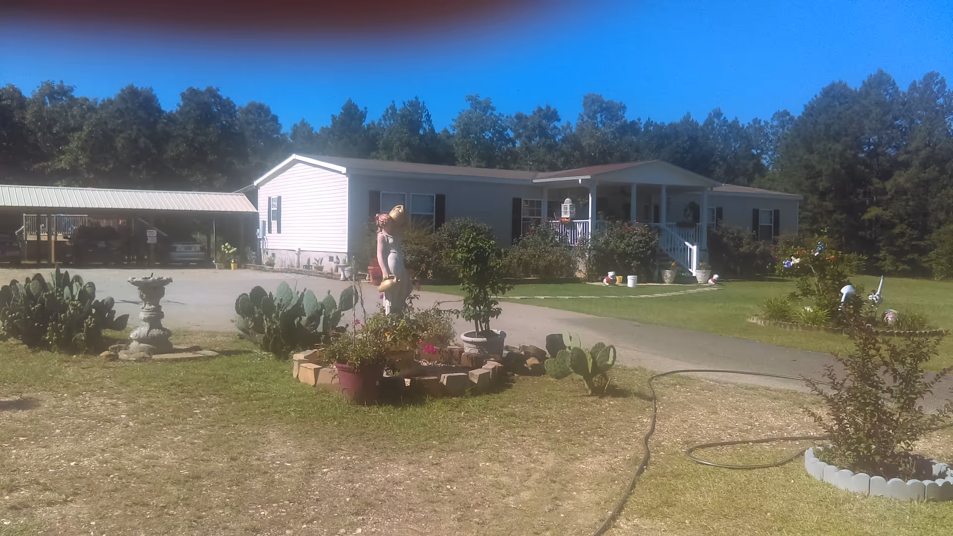 Front view of C R Neeley senior living facility with garden, cactus, and covered porch.