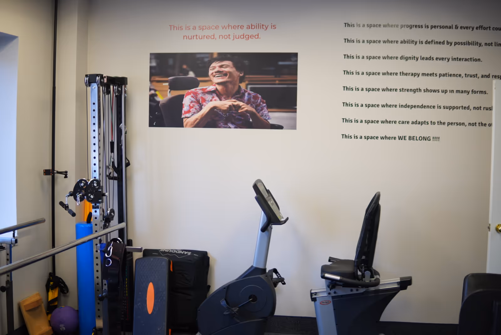 Interior gym in a senior living facility with stationary bikes and weight equipment.