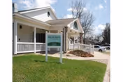 Front exterior of Maria's Adult Care Home with a porch, sign, and parking lot.