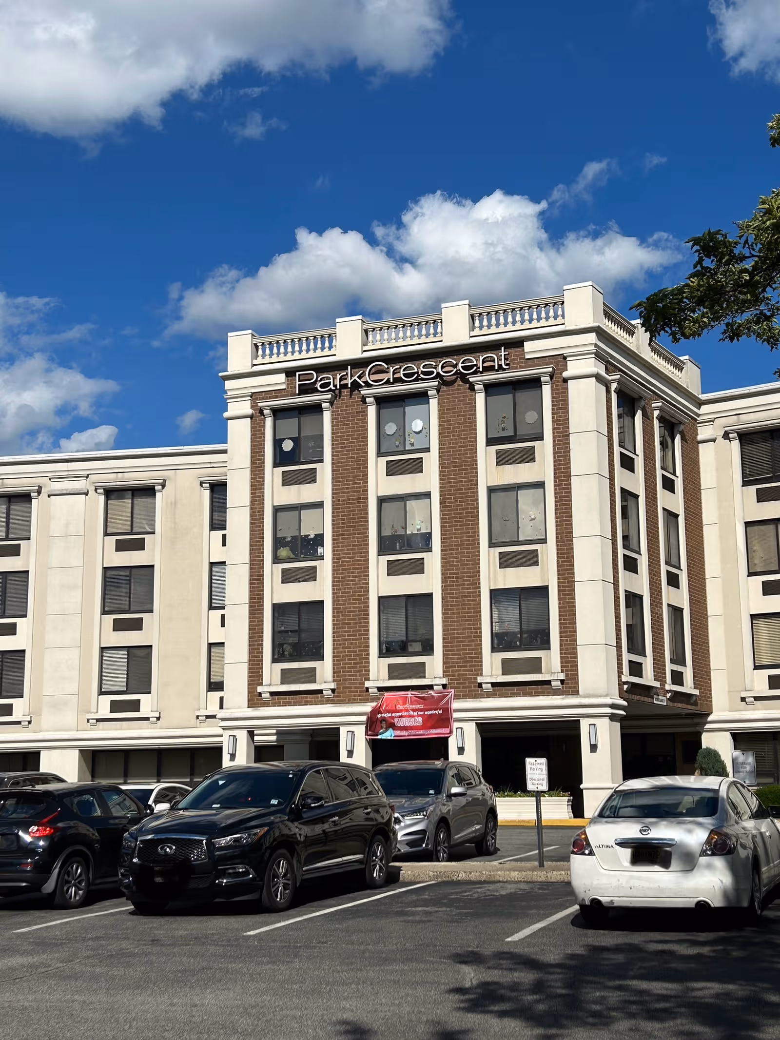 Front view of Park Crescent Healthcare and Rehabilitation Center building with parked cars.