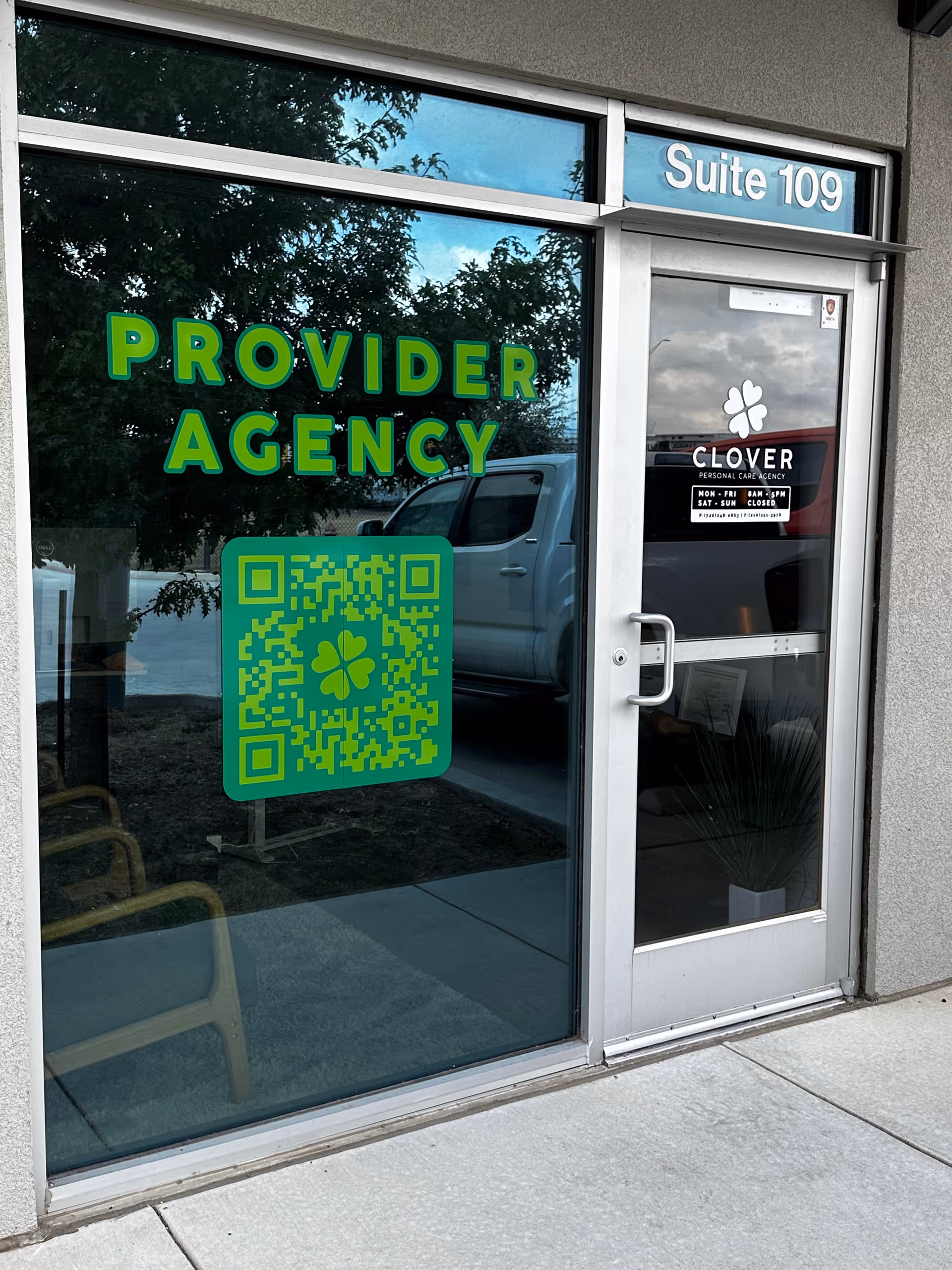 Exterior glass storefront with green PROVIDER AGENCY sign and Clover door.