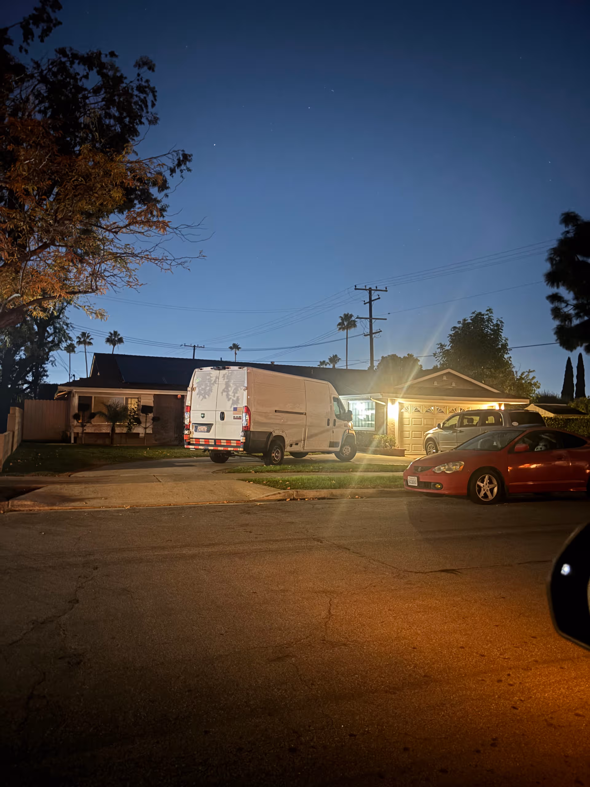 Night exterior of a single-story Agape Congregate Living facility with a white van in front.